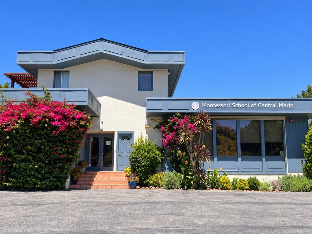 The front of the Montessori School of Central Marin building with its sign and blooming bougainvillea